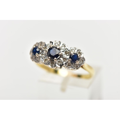 97 - A SAPPHIRE AND DIAMOND RING, three circular cut blue sapphires, set with a surround of single cut di... 