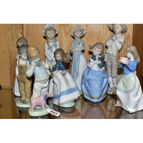 327 - A GROUP OF ELEVEN NAO FIGURINES OF CHILDREN, to include a girl with puppy, a boy holding a telephone... 