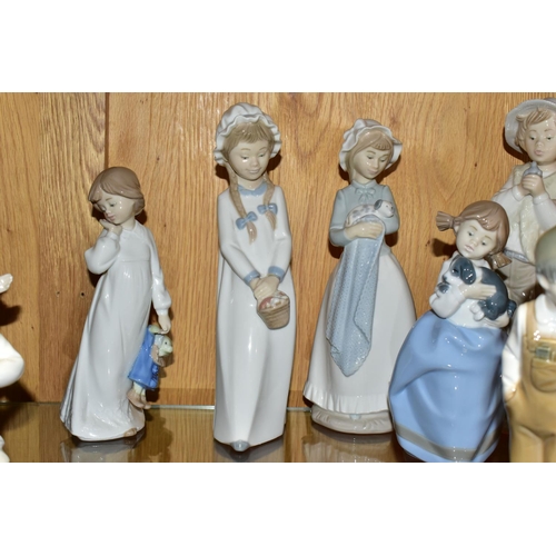 327 - A GROUP OF ELEVEN NAO FIGURINES OF CHILDREN, to include a girl with puppy, a boy holding a telephone... 