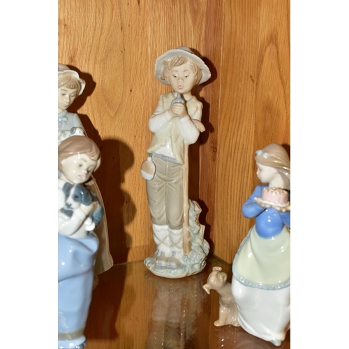 327 - A GROUP OF ELEVEN NAO FIGURINES OF CHILDREN, to include a girl with puppy, a boy holding a telephone... 