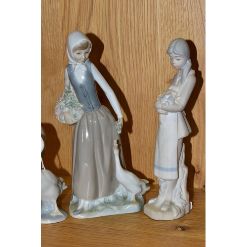 335 - THREE FIGURINES INCLUDING NAO, AND A LLADRO DUCK, comprising Nao 'Reclining Ballerina' and 'Girl Fee... 