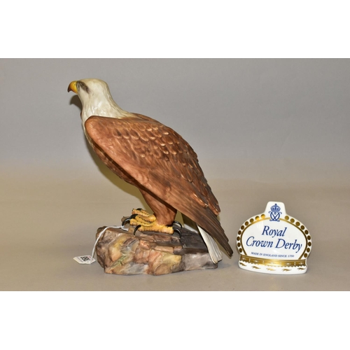 368 - A ROYAL CROWN DERBY EAGLE AND CROWN NAMESTAND, the matt glazed bald eagle modelled perched on a rock... 