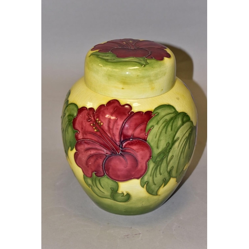 370 - A LARGE MOORCROFT POTTERY GINGER JAR AND COVER, 'Hibiscus' pattern on a graduated yellow green groun... 