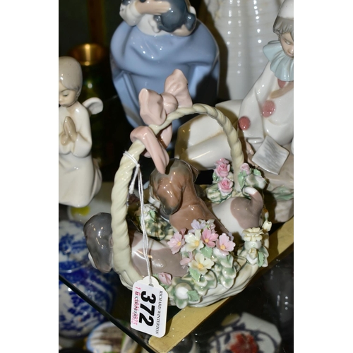 372 - SIX LLADRO AND NAO FIGURES, comprising Lladro 'A Litter of Love' three puppies in a basket, no 1441,... 