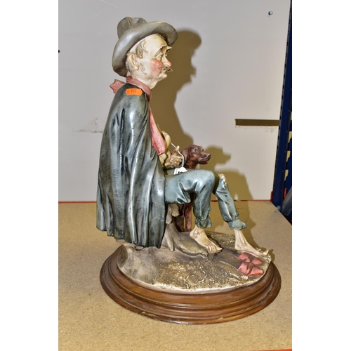 385 - A LARGE CAPODIMONTE FIGURE, featuring a seated old man with his dog and a bottle of wine, height 45c... 