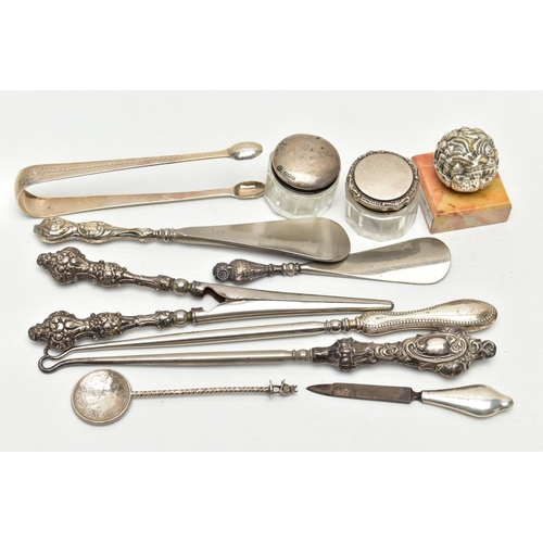 156 - ELEVEN SILVER NOVELTIES, mainly early 20th century pieces, to include sugar tongs, two button hooks ... 