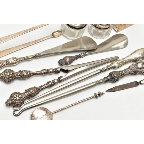 156 - ELEVEN SILVER NOVELTIES, mainly early 20th century pieces, to include sugar tongs, two button hooks ... 