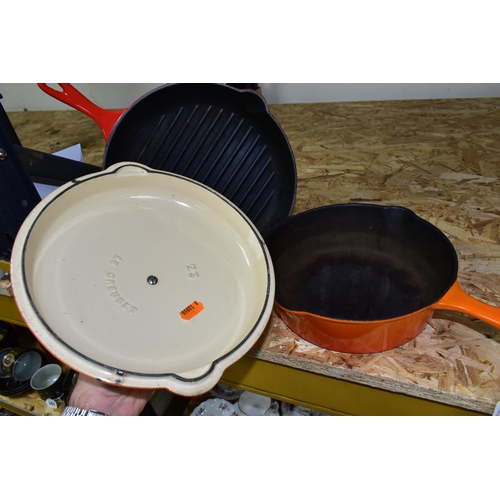 327 - A SET OF LE CREUSET VOLCANIC ORANGE CAST IRON OVEN WARE, comprising a classic 23cm  lidded saucepan/... 