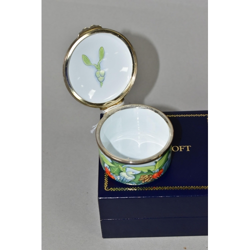 364 - A BOXED MOORCROFT ENAMELS TRINKET BOX, of cylindrical form, decorated with sprigs of fir, fir cones,... 