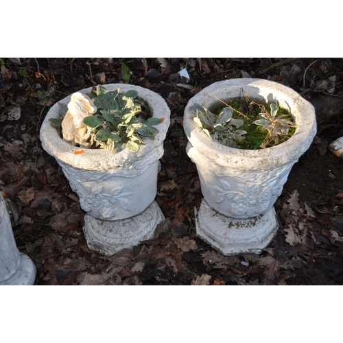 1005 - A PAIR OF TWO PIECE COMPOSITE GARDEN URNS with foliate detail to bowl height 50cm