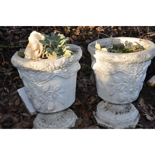 1005 - A PAIR OF TWO PIECE COMPOSITE GARDEN URNS with foliate detail to bowl height 50cm