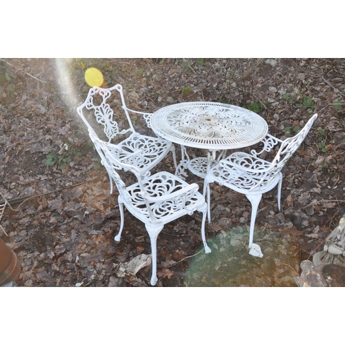 1007 - A PAINTED ALUMINIUM GARDEN TABLE 79cm in diameter and three chairs (4)