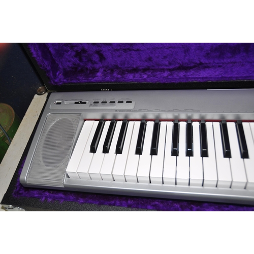 1062 - A YAMAHA NP-30 PORTABLE GRAND ELECTRIC PIANO in semi flight case with power supply, expression pedal... 