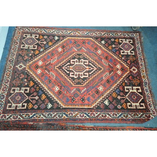 1309 - A TURKISH MILAS WOOLEN RUG, geometric design within a black field, 163cm x 115cm and a similar large... 