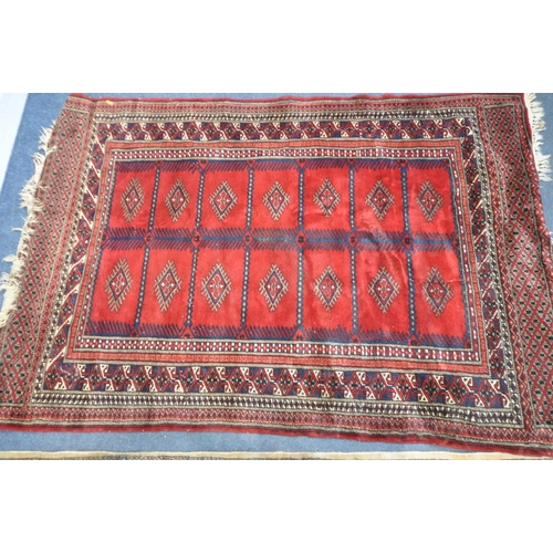 1321 - TWO 20TH CENTURY WOOLLEN RUGS one with red field 186cm x 124cm and the other russet coloured, 198cm ... 