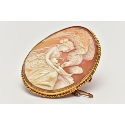 22 - A YELLOW METAL CAMEO BROOCH, of an oval form, carved shell cameo depicting Hebe and Zeus in eagle fo... 