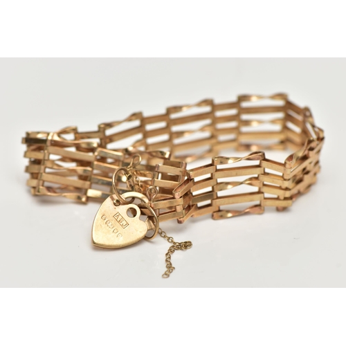 3 - A 9CT GOLD GATE BRACELET, five bar gate bracelet, fitted with a heart padlock clasp and additional s... 