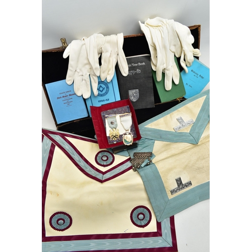 52 - A CASE OF MASONIC REGALIA, to include two aprons, various books, year books, by laws etc., three pai... 