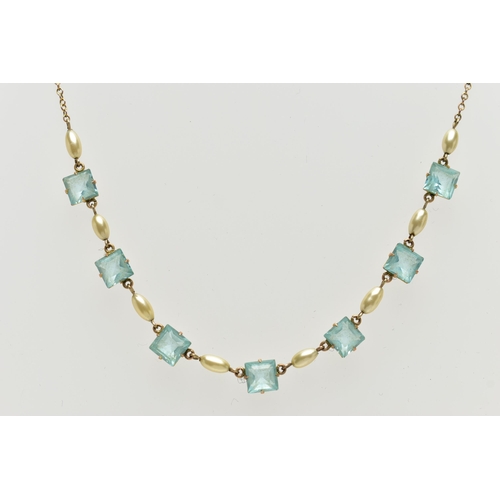 61 - A MID 20TH CENTURY YELLOW METAL NECKLACE, set with seven pale blue square cut pastes, each claw set ... 