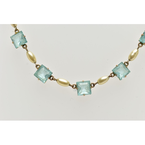 61 - A MID 20TH CENTURY YELLOW METAL NECKLACE, set with seven pale blue square cut pastes, each claw set ... 