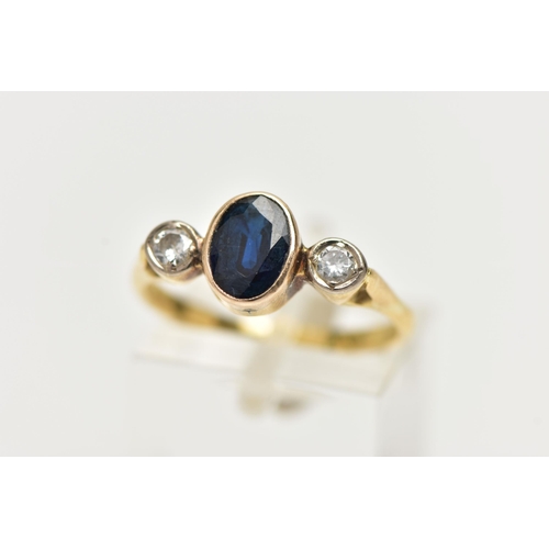 7 - A YELLOW METAL SAPPHIRE AND DIAMOND RING, centering on an oval cut deep blue sapphire, collet set, f... 