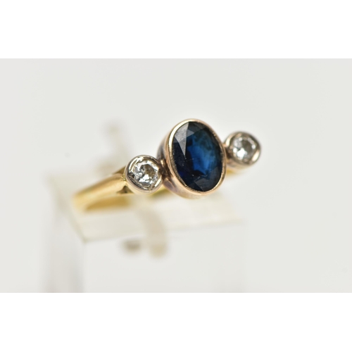 7 - A YELLOW METAL SAPPHIRE AND DIAMOND RING, centering on an oval cut deep blue sapphire, collet set, f... 