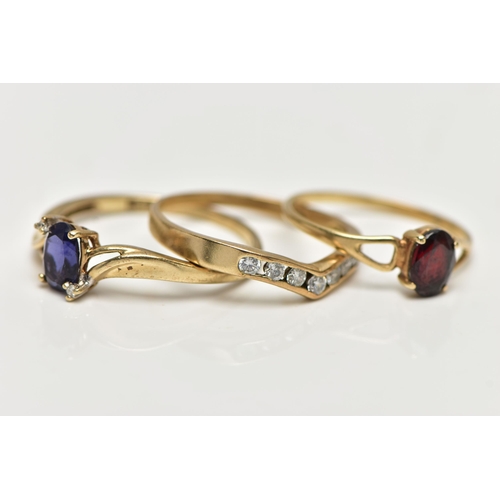 8 - THREE 9CT GOLD GEM SET RINGS, the first designed with a four claw set, oval cut tanzanite, flanked w... 