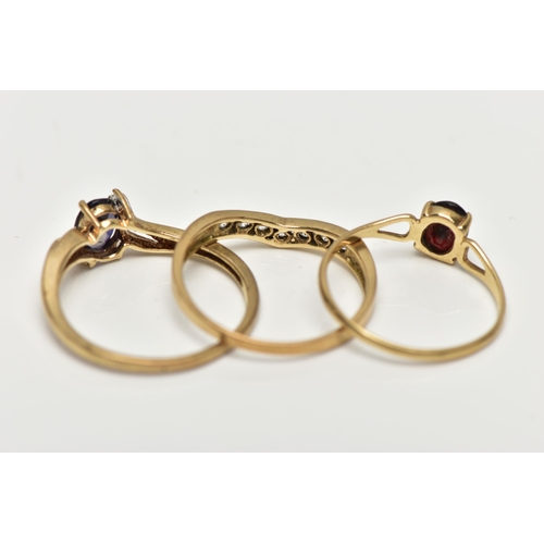 8 - THREE 9CT GOLD GEM SET RINGS, the first designed with a four claw set, oval cut tanzanite, flanked w... 