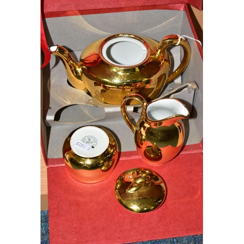 344 - A BOXED ROYAL WORCESTER GOLD LUSTRE THREE PIECE TEA SET, teapot shape 5, size 4, milk jug and sugar ... 