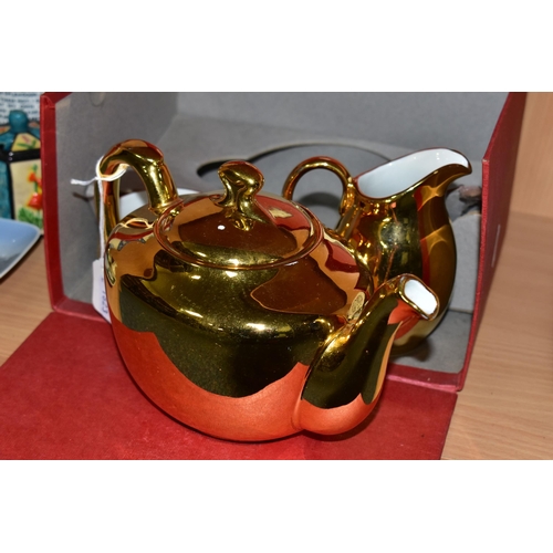 344 - A BOXED ROYAL WORCESTER GOLD LUSTRE THREE PIECE TEA SET, teapot shape 5, size 4, milk jug and sugar ... 