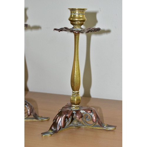 367 - A PAIR OF BRASS AND COPPER CANDLESTICKS, in the form of flowers with foliate scrolling bases height ... 