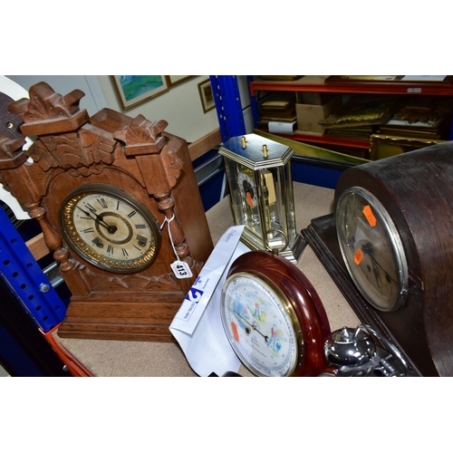 413 - A GROUP OF SEVEN CLOCKS, comprising a chrome alarm clock, quartz black mantel clock, a wooden 'Halle... 