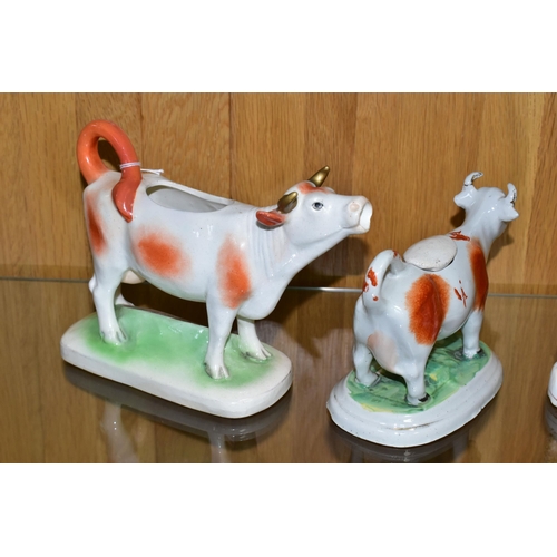 516 - TWO COW CREAMERS, both with brown patches, comprising an early twentieth century Royal Dux cow cream... 