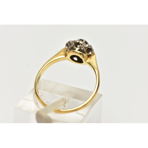 72 - A DIAMOND CLUSTER RING, set with a principal single cut diamond, within an old cut diamond surround,... 