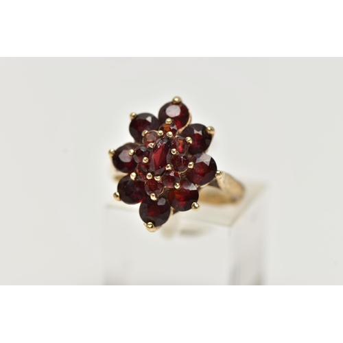 77 - A 9CT YELLOW GOLD GARNET CLUSTER RING, of a marquise shape outline set with marquise and circular cu... 