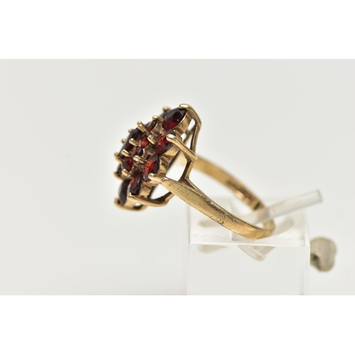 77 - A 9CT YELLOW GOLD GARNET CLUSTER RING, of a marquise shape outline set with marquise and circular cu... 