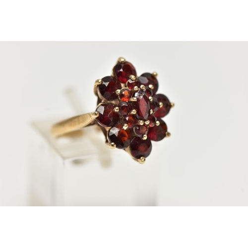 77 - A 9CT YELLOW GOLD GARNET CLUSTER RING, of a marquise shape outline set with marquise and circular cu... 