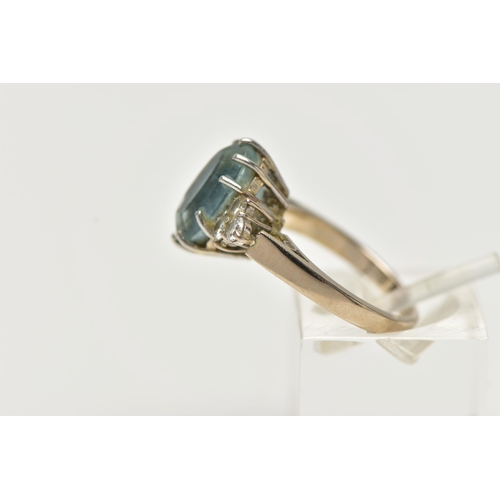 79 - AN 18CT WHITE GOLD AQUAMARINE AND DIAMOND DRESS RING, set with an oval cut aquamarine, with diamond ... 