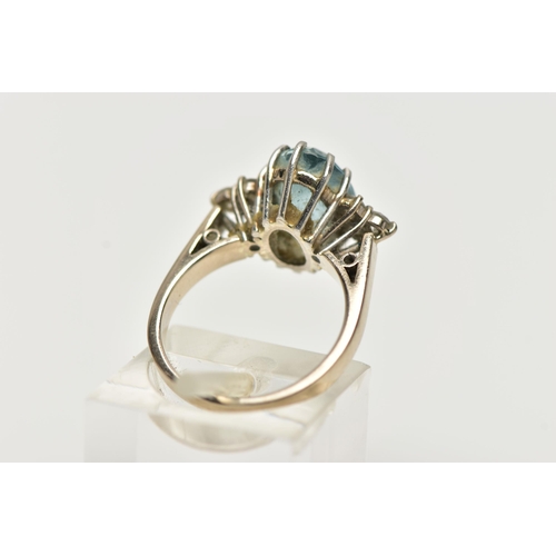 79 - AN 18CT WHITE GOLD AQUAMARINE AND DIAMOND DRESS RING, set with an oval cut aquamarine, with diamond ... 