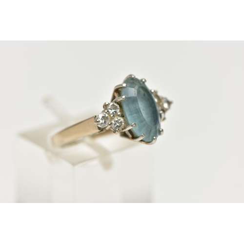 79 - AN 18CT WHITE GOLD AQUAMARINE AND DIAMOND DRESS RING, set with an oval cut aquamarine, with diamond ... 