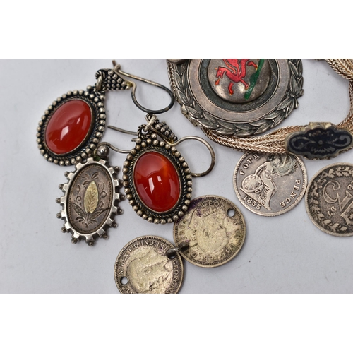 98 - AN ASSORTMENT OF SILVER AND WHITE METAL, the first a silver medallion, enamel detail of a Welsh drag... 