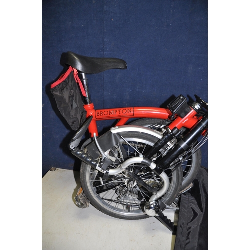 1102 - A BROMPTON FOLDING BIKE WITH BAG in red