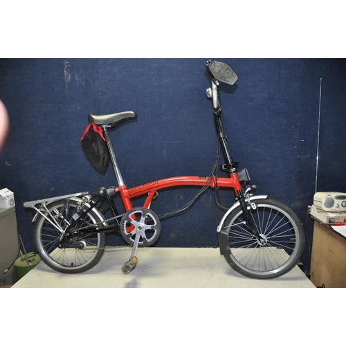 1102 - A BROMPTON FOLDING BIKE WITH BAG in red