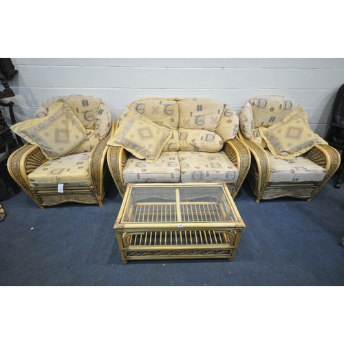 1373 - A WICKER CONSERVATORY SUITE, comprising a two seater settee, length 149cm, a pair of armchairs, and ... 