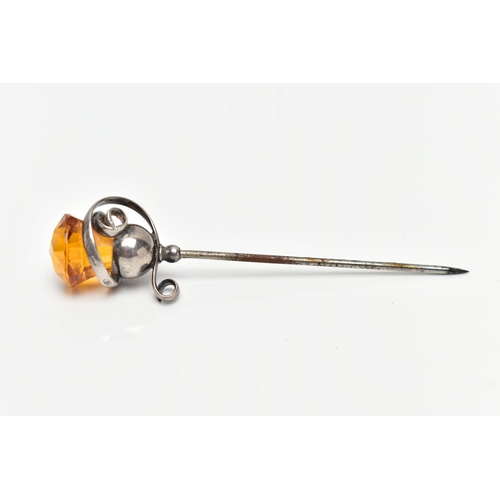 1 - AN EARLY 20TH CENTURY 'CHARLES HORNER' HAT PIN, white metal scrolling around an orange paste thistle... 