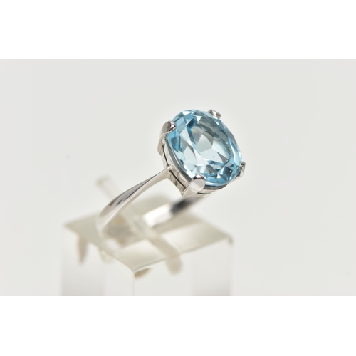 2 - A MODERN 18CT GOLD TOPAZ RING, an oval cut light blue topaz, approximate dimensions length 12mm x wi... 