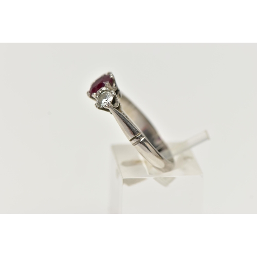 36 - A PLATINUM RUBY AND DIAMOND THREE STONE RING, centering on an oval cut ruby, flanked with two round ... 