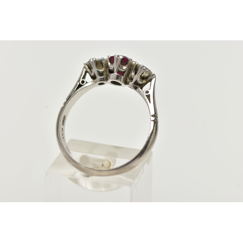 36 - A PLATINUM RUBY AND DIAMOND THREE STONE RING, centering on an oval cut ruby, flanked with two round ... 