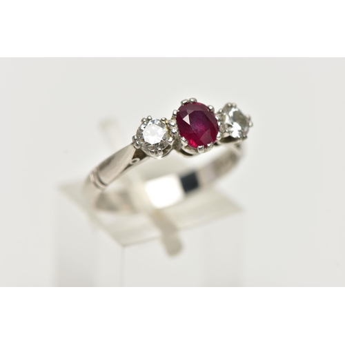 36 - A PLATINUM RUBY AND DIAMOND THREE STONE RING, centering on an oval cut ruby, flanked with two round ... 