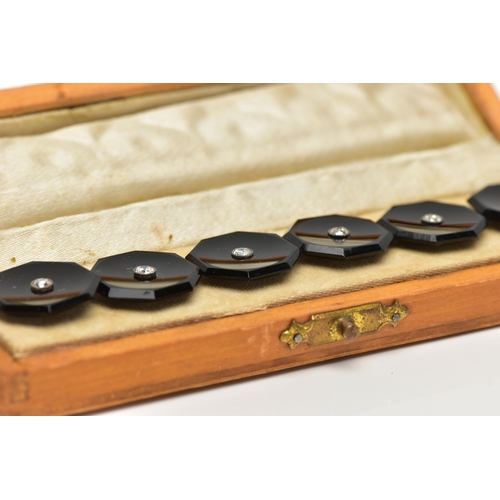 43 - A CASED SET OF SIX MID 20TH CENTURY, ONYX AND DIAMOND DRESS STUDS, each highly polished onyx studs o... 